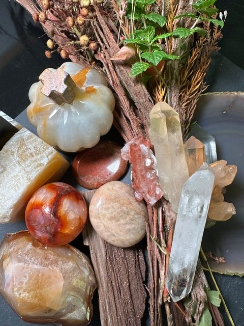 Smoky quartz, amber, and warm earth-toned mineral specimens from The Botanica Lifestyle Autumn Edit